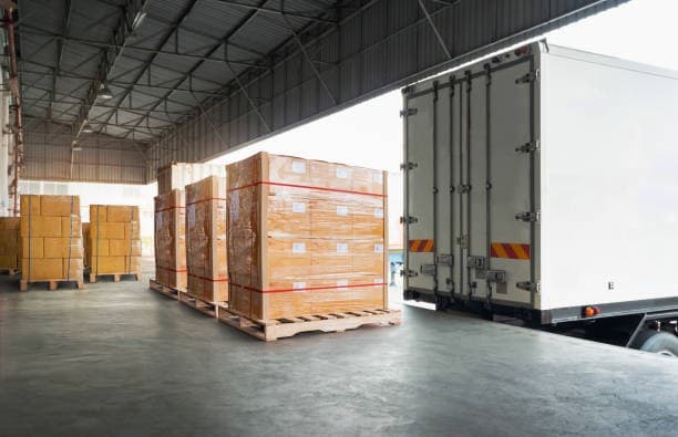 Two wrapped pallets loaded and secured inside a Raymond Logistics trailer